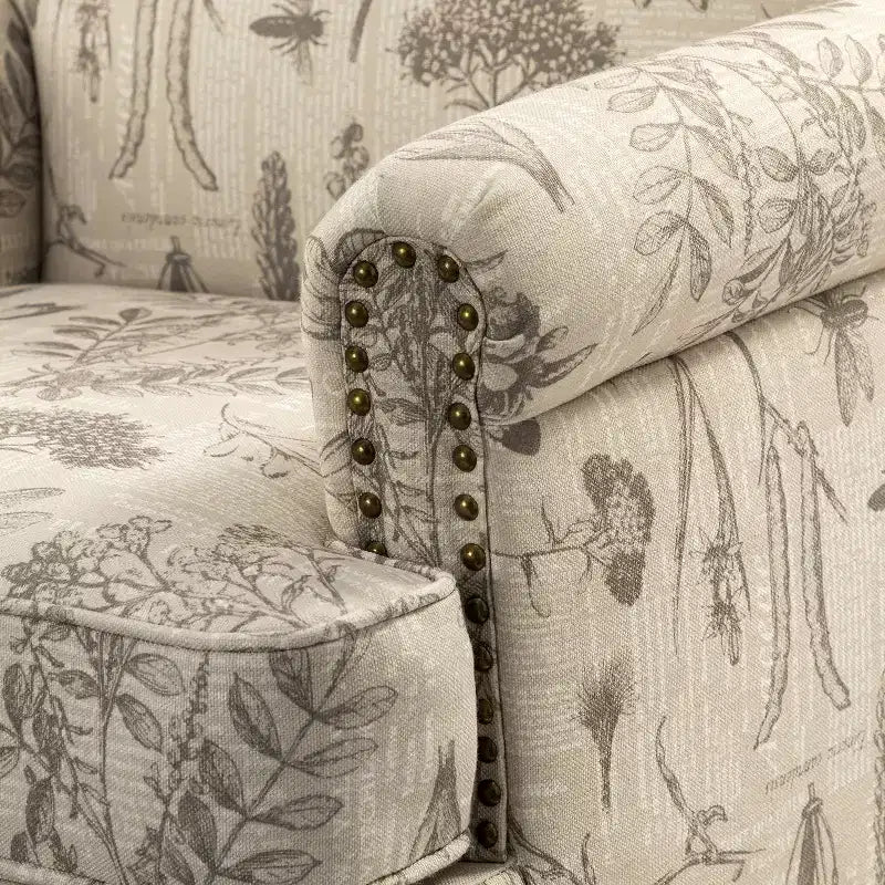 Fauteuil à accoudoirs pleins et dossier en forme de bosse de chameau Yahweh en bois de transition, avec garniture en tissu à motifs floraux | ART OF LIVING DES