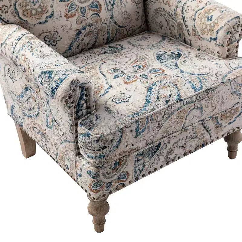 Fauteuil à accoudoirs pleins et dossier en forme de bosse de chameau Yahweh en bois de transition, avec garniture en tissu à motifs floraux | ART OF LIVING DES